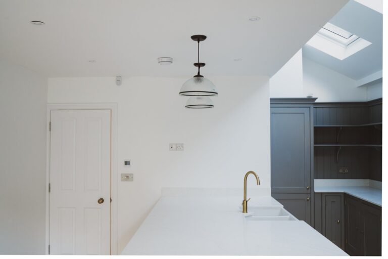 Modern kitchen with skylight and pendant lights — Fulham SW6