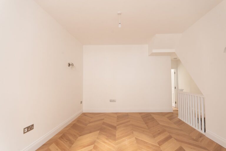 Empty room with wooden floor and white walls — Fulham SW6