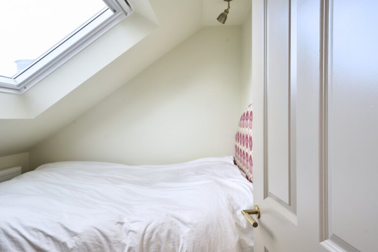 Cosy bedroom with skylight and white bedding — Acton W3